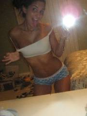 Babe in top and mini skirt erotically poses on home cam